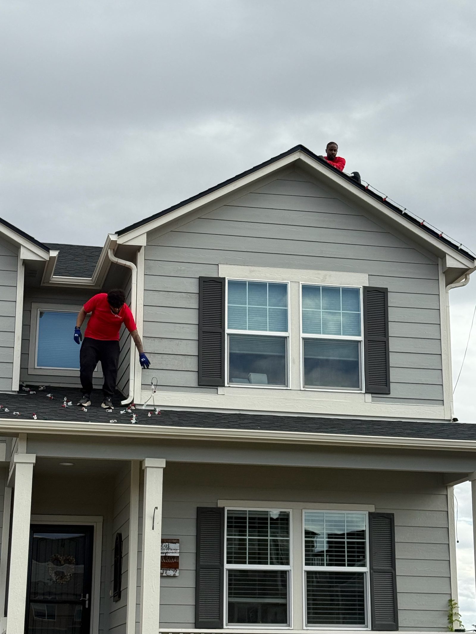 Professional Christmas light installation crew on roof installing LED lights on the Front Range