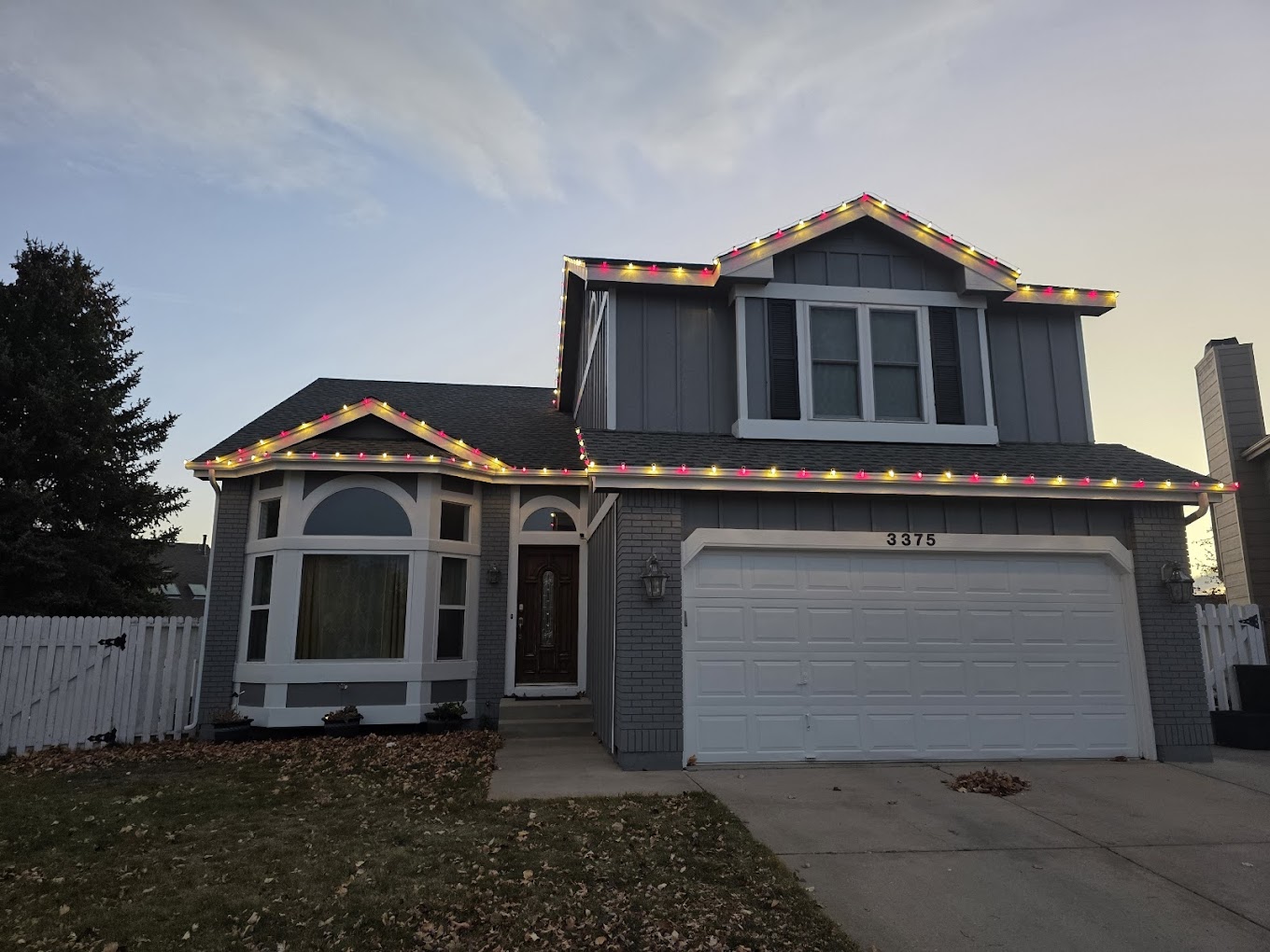Two-story multicolor lights Two-story Front Range home decorated with multicolor roofline Christmas lights for the holiday season